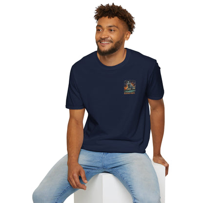 Man wearing a navy blue t-shirt with a logo sitting on a white stool against a white background