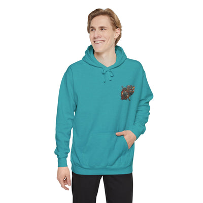 Person wearing a teal hoodie with a pocket design on a white background