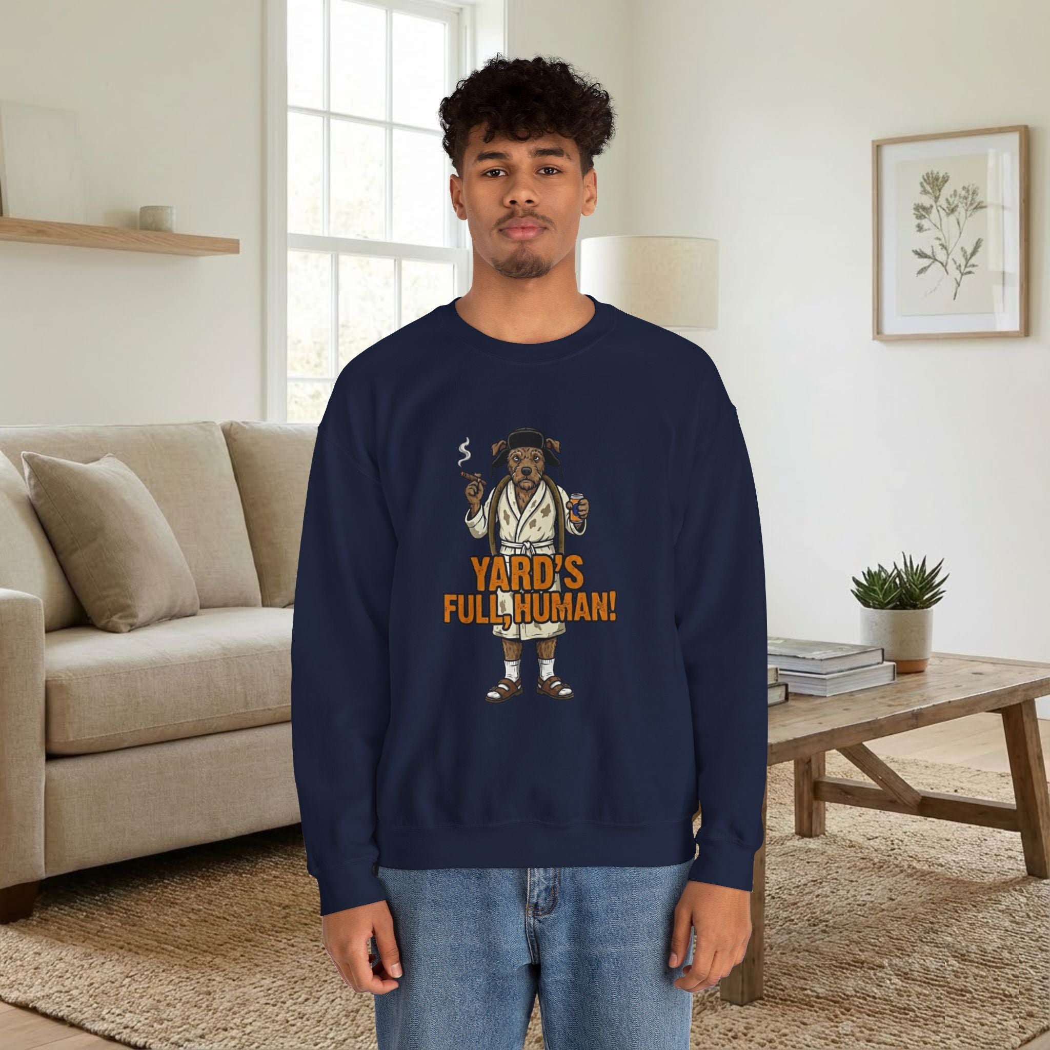 Person wearing a navy blue sweatshirt with a graphic design in a living room.