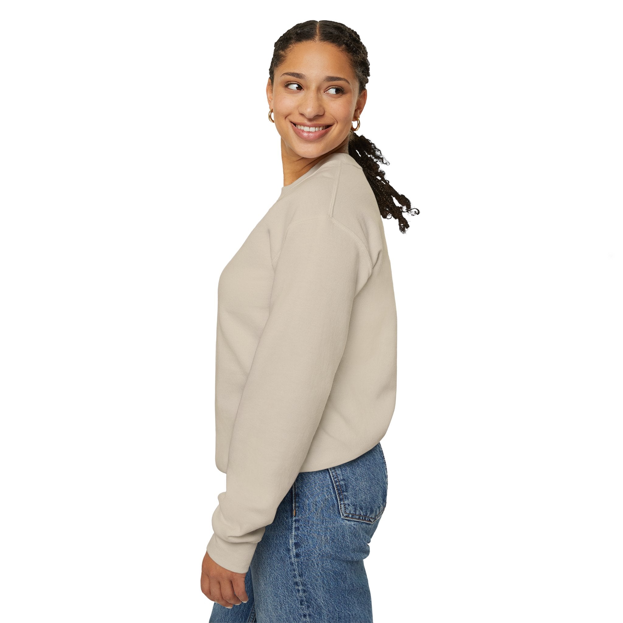 Woman wearing a beige sweatshirt and blue jeans on a white background