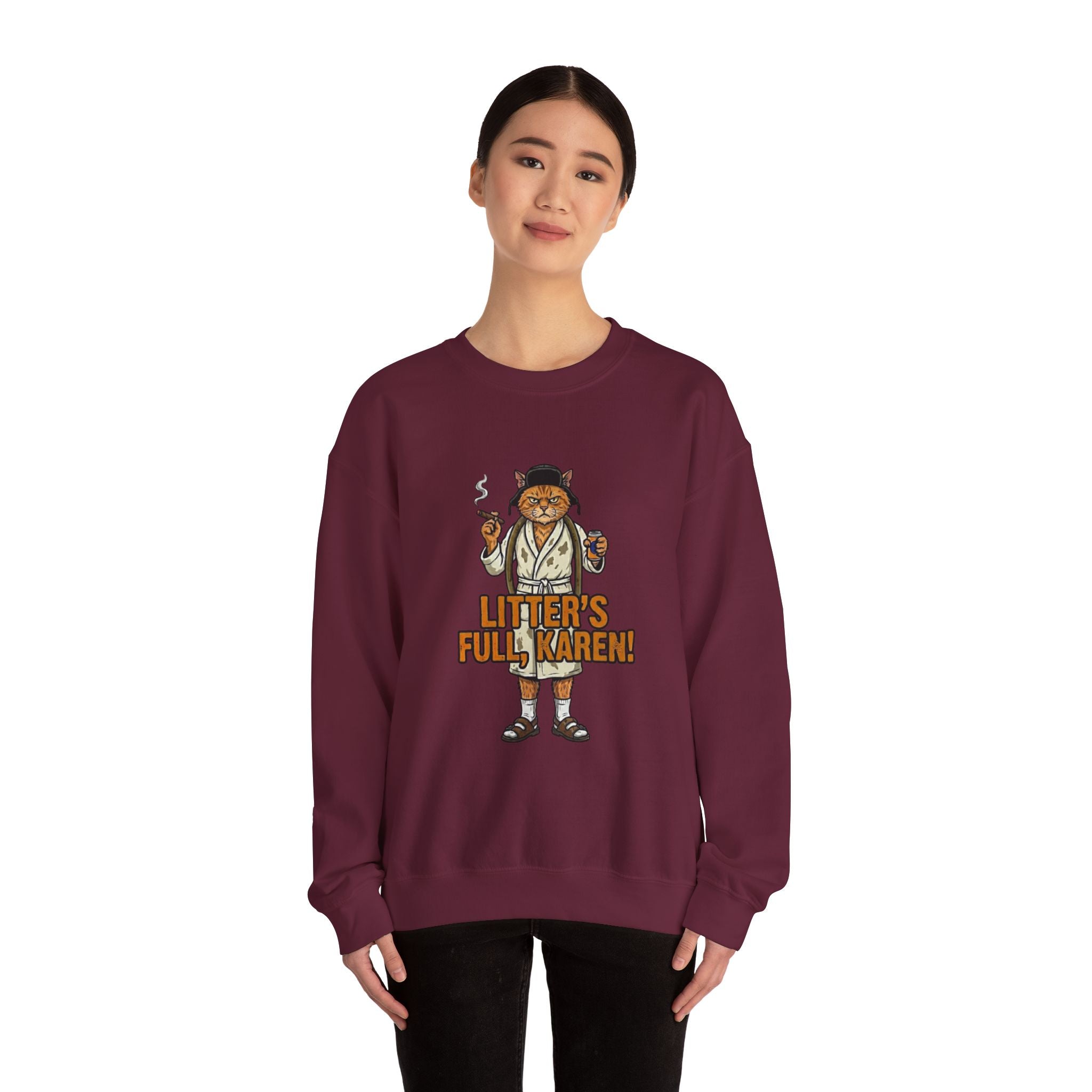 Person wearing a maroon sweatshirt with a graphic design and text on a white background
