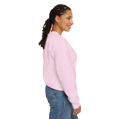 Woman wearing a pink sweatshirt and blue jeans on a white background