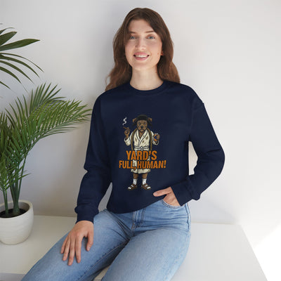 Woman wearing a navy blue sweatshirt with a graphic design sitting on a white surface.