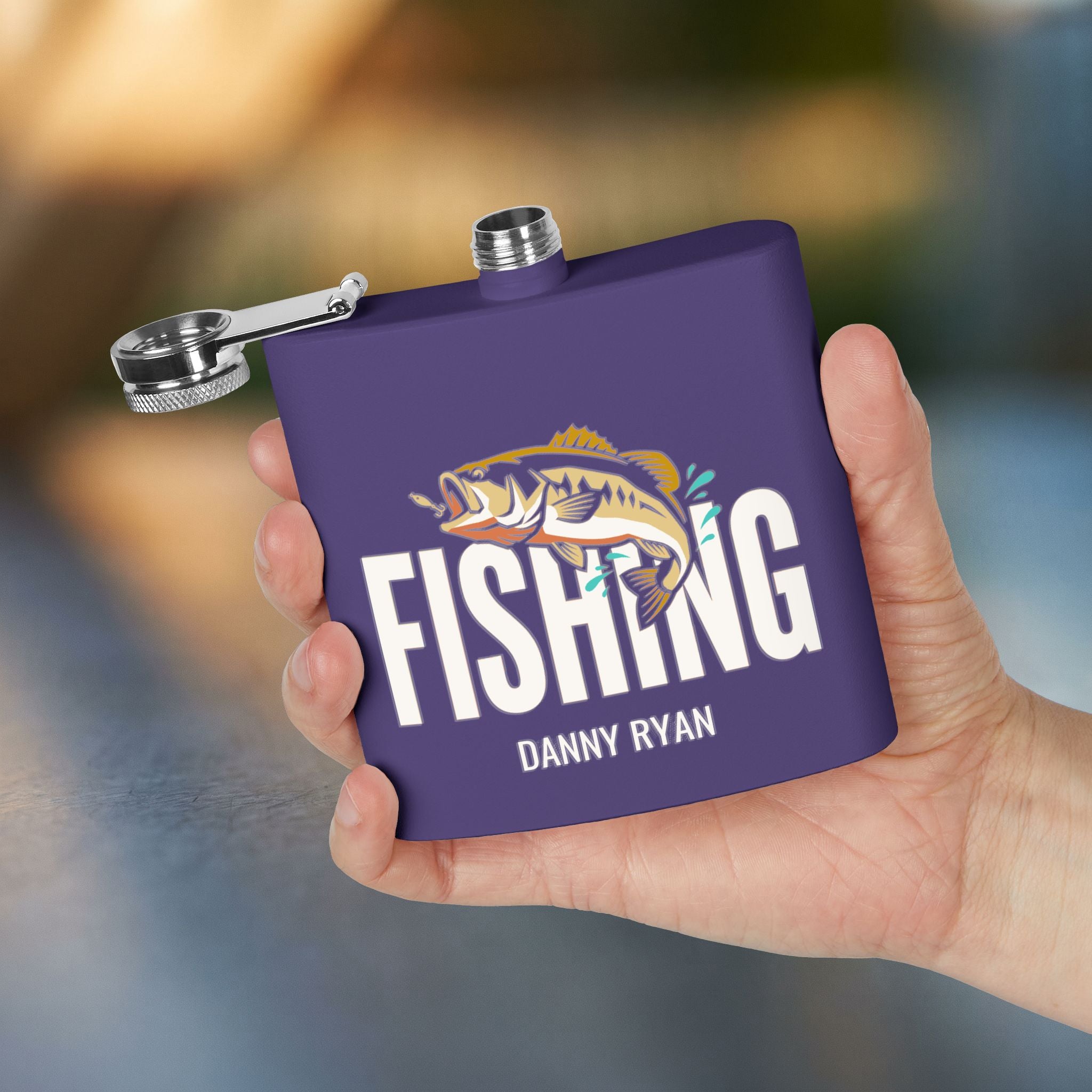 Gone Fishin’ Bass Flask bass fishing gift flask in Purple — held in hand