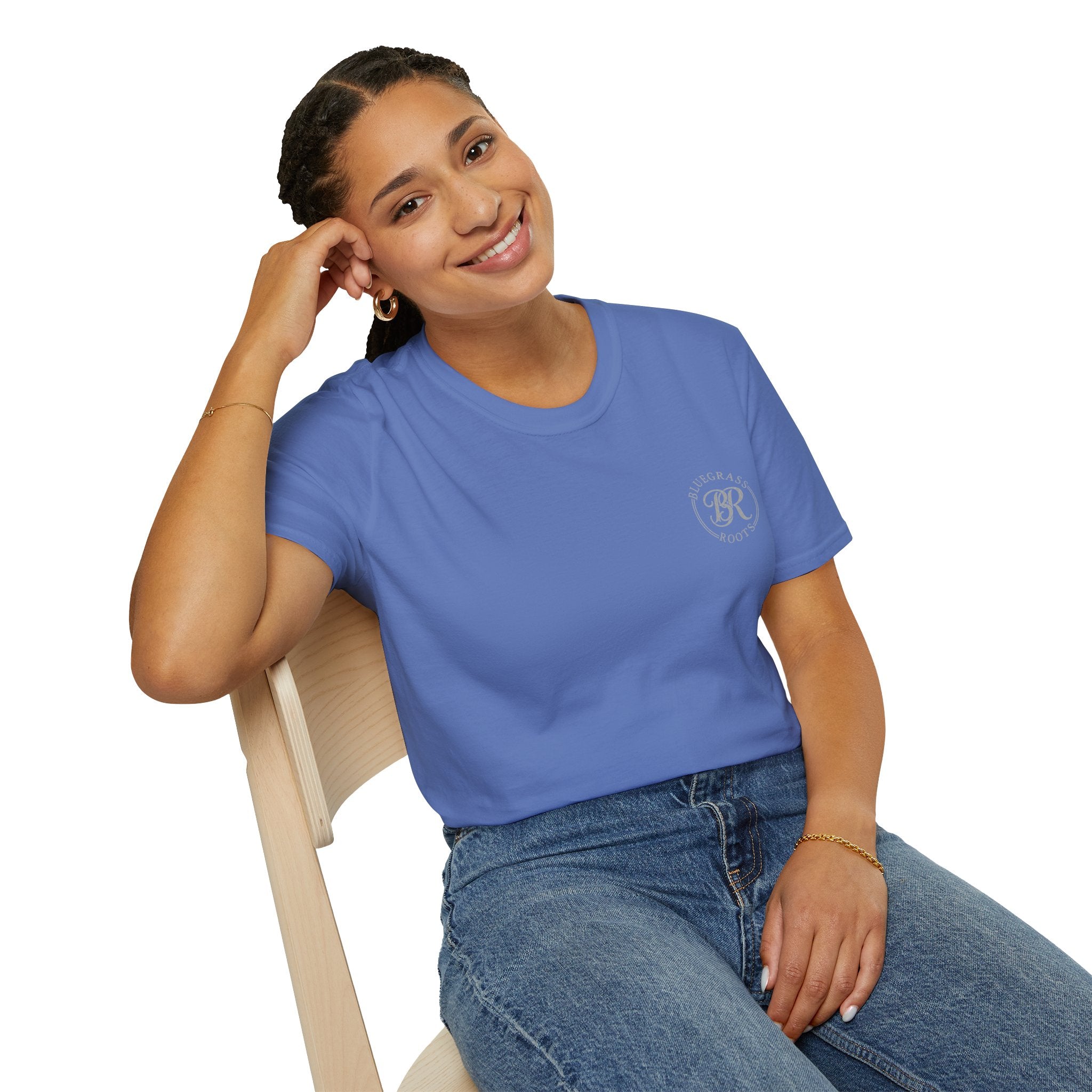 Woman wearing a blue t-shirt with a logo, sitting on a chair against a white background