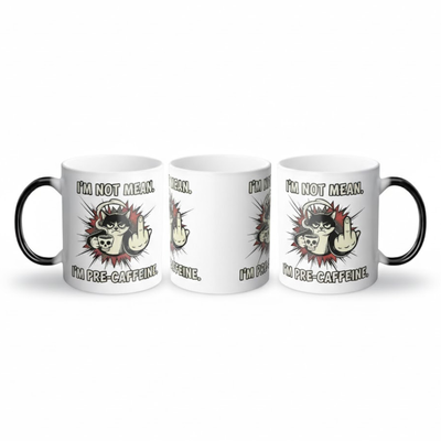 Three-angle view of the ceramic mug showing the fully revealed "I'm Not Mean, I'm Pre-Caffeine" grumpy cat graphic.