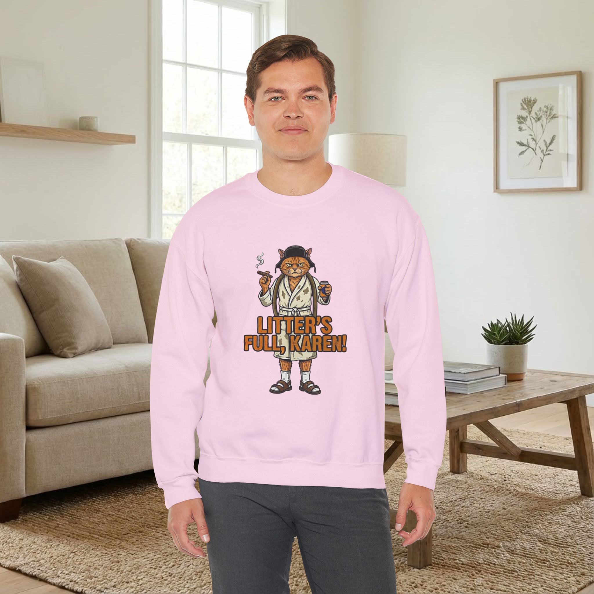 Person wearing a pink sweatshirt with a graphic design in a living room.