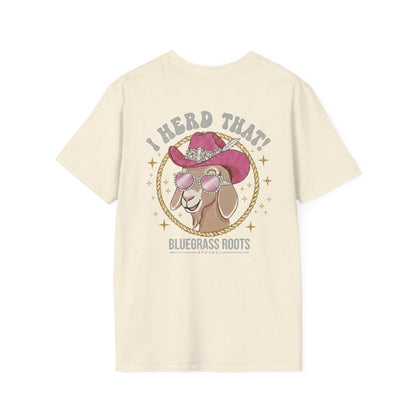 Beige t-shirt with a graphic of a goat wearing a cowboy hat and sunglasses, text 'I Herd That! Bluegrass Roots' on a white background.