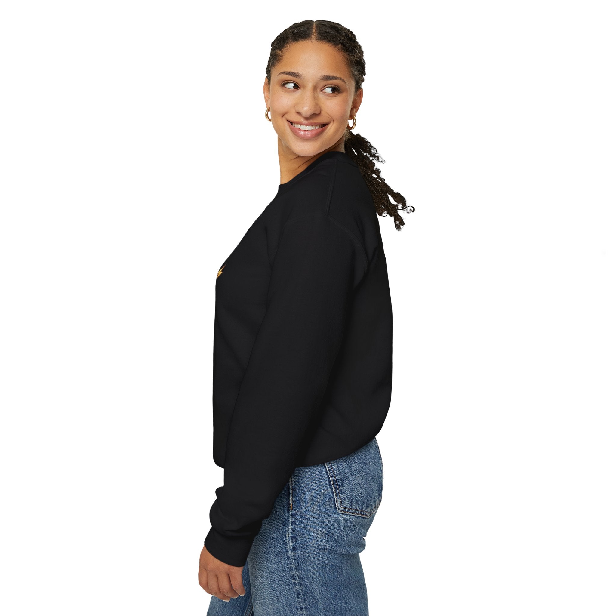 Woman wearing a black sweatshirt and blue jeans on a white background