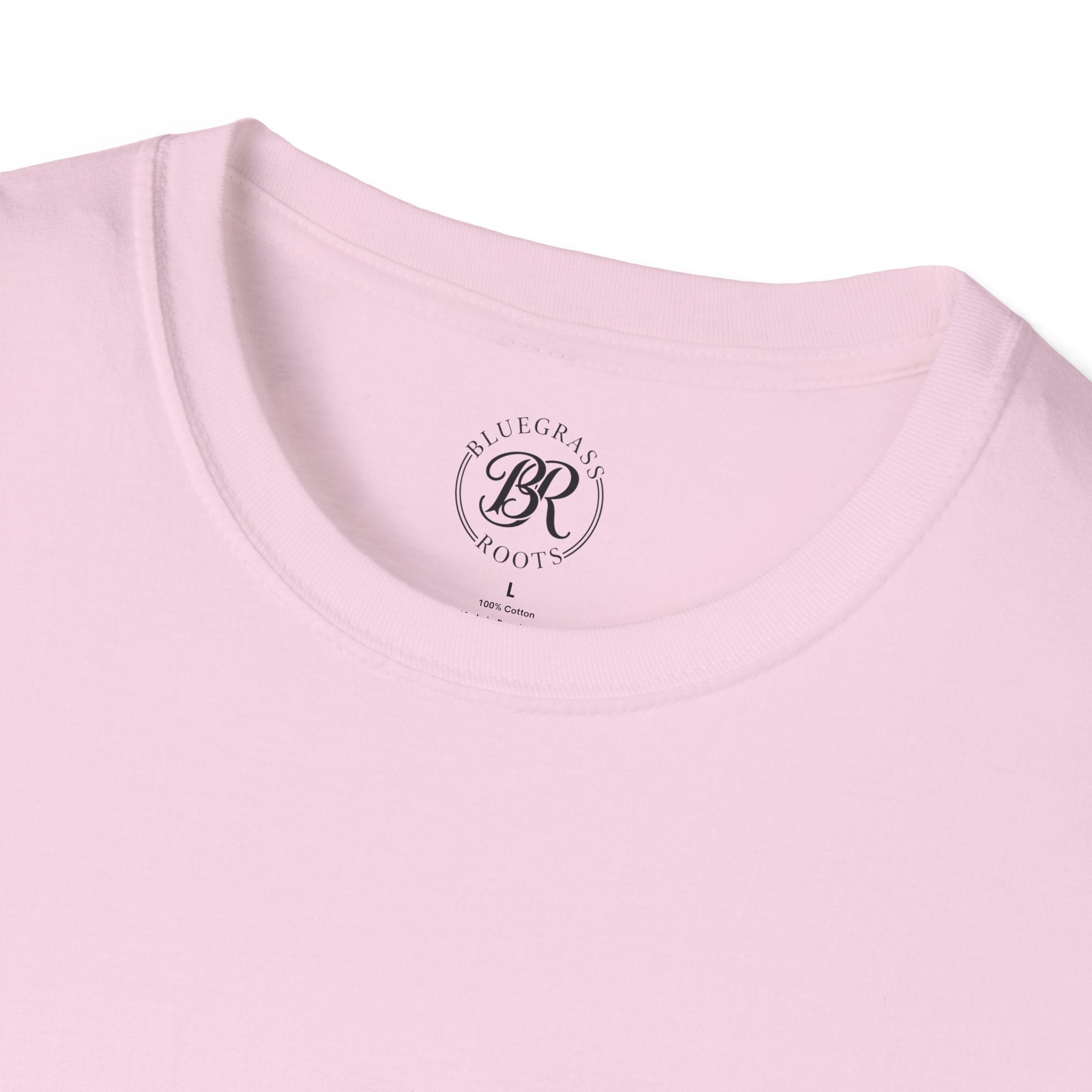 Close-up of a pink t-shirt with 'Bluegrass Roots' logo on a white background