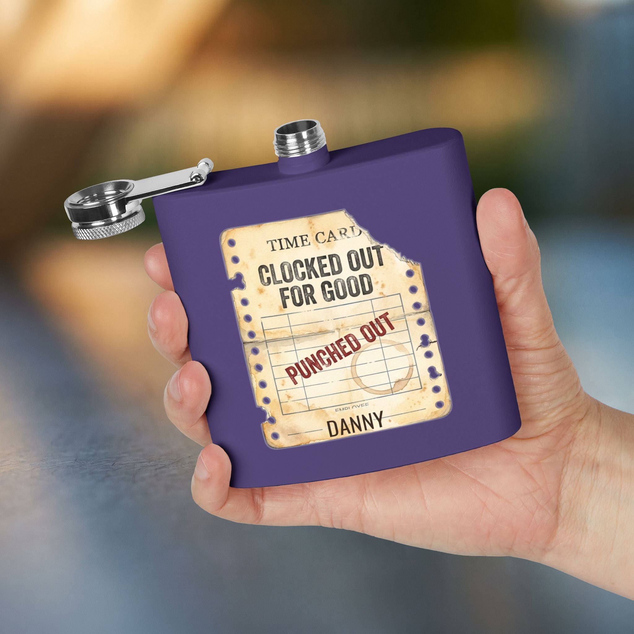 Clocked Out For Good personalized retirement gift flask in Purple — held in hand