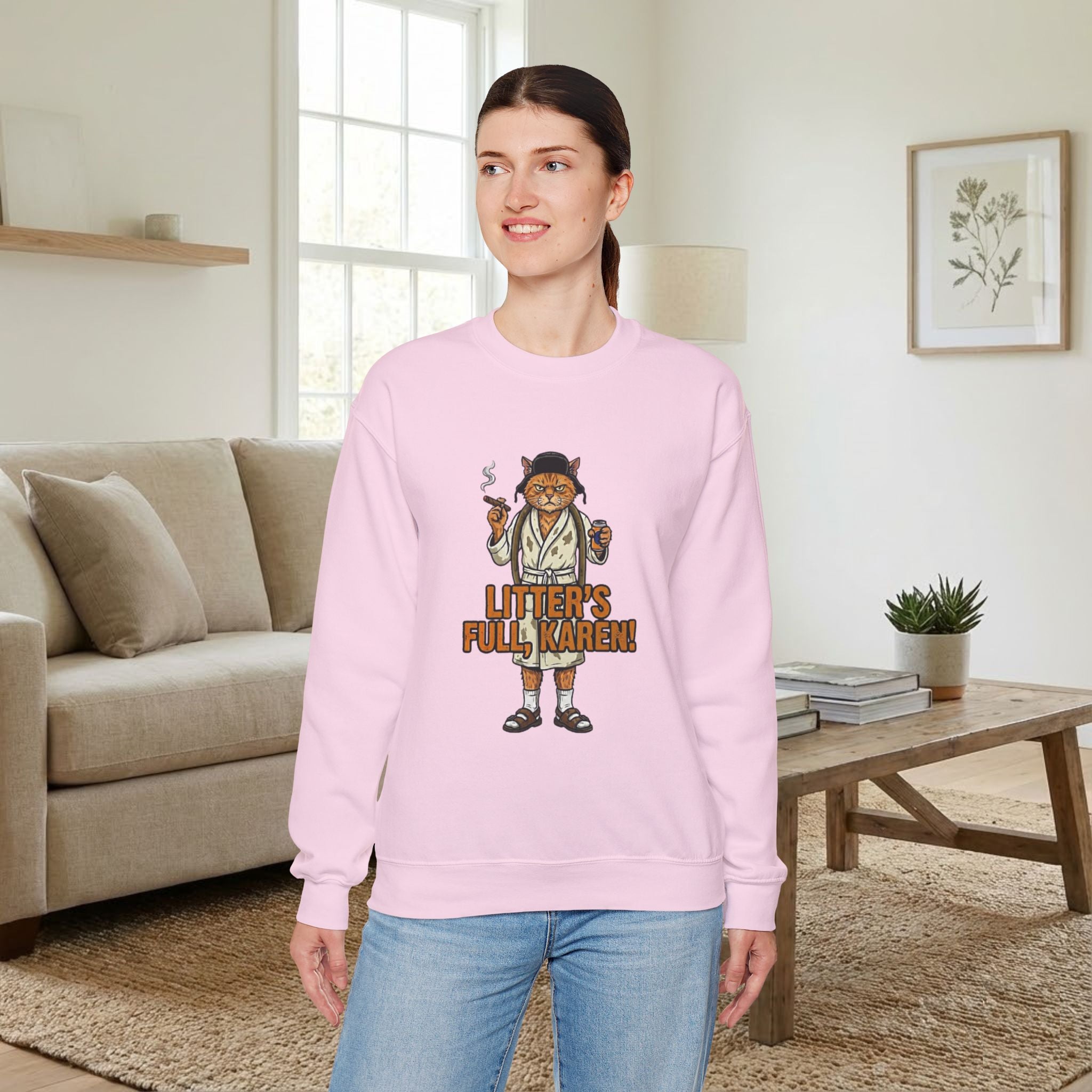 Woman wearing a pink sweatshirt with a graphic design in a living room.