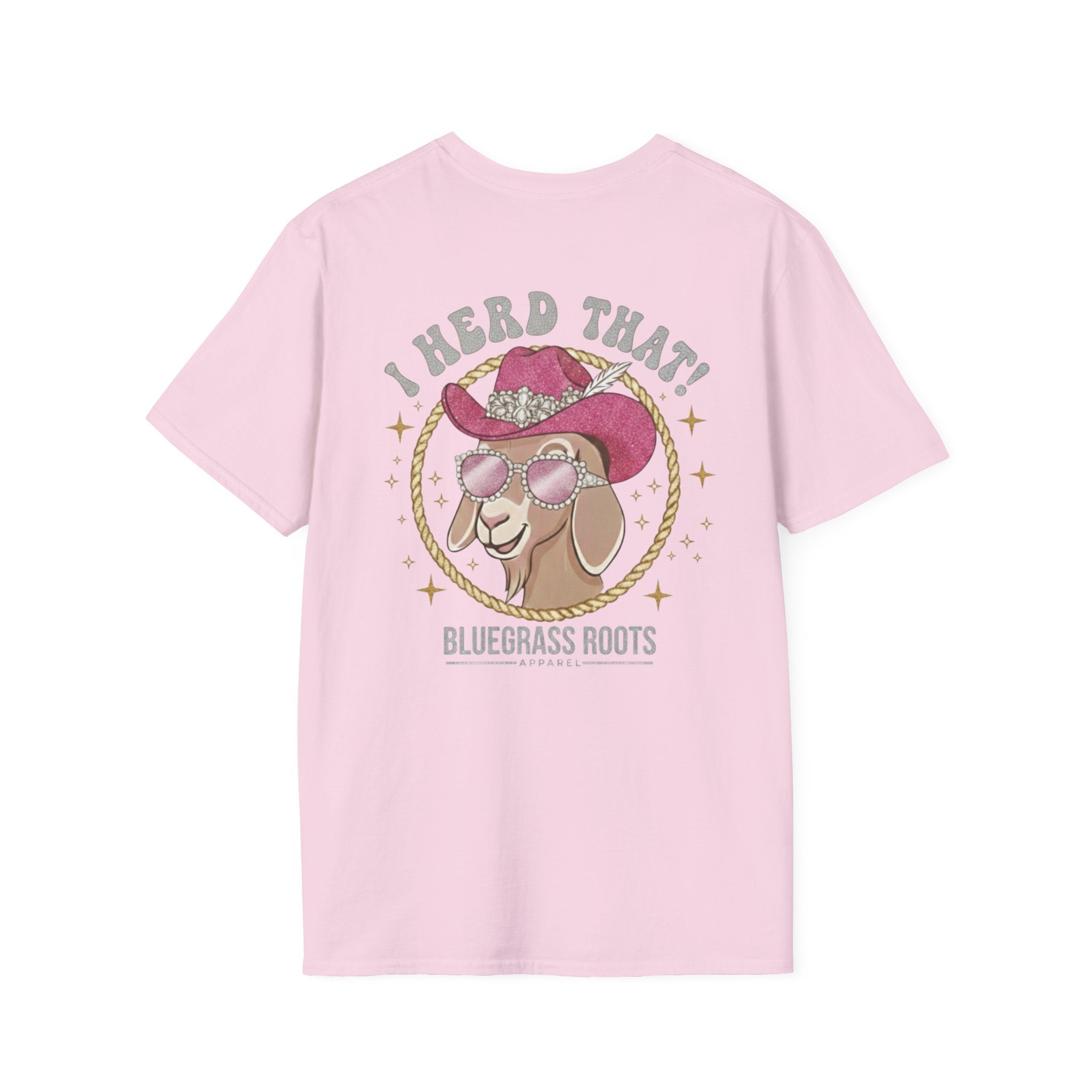 Pink t-shirt with a graphic of a goat wearing a cowboy hat and sunglasses, text 'I Herd That! Bluegrass Roots' on a white background.