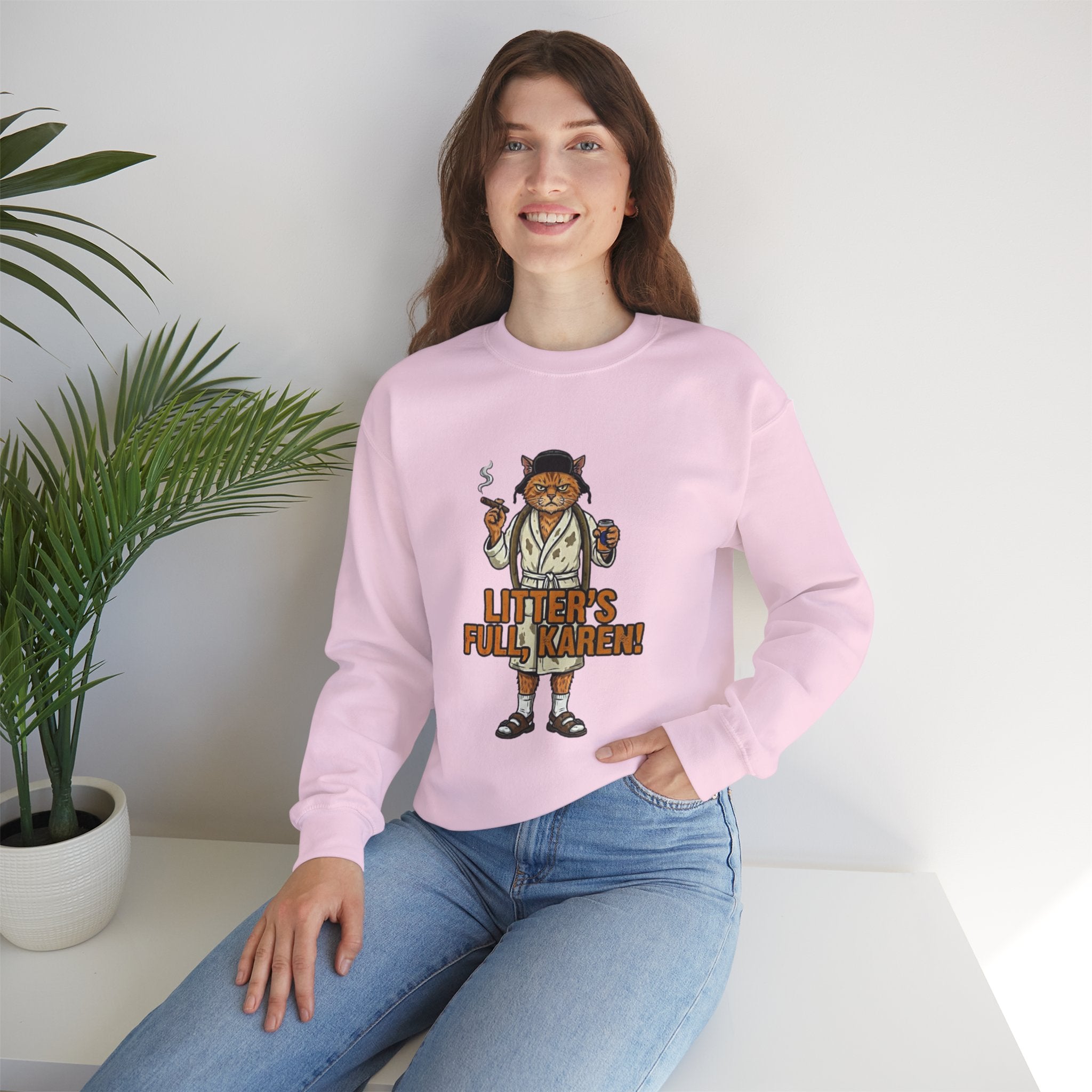 Person wearing a pink sweatshirt with a graphic design sitting on a white surface.