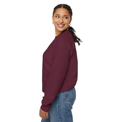 Woman wearing a maroon sweatshirt and blue jeans on a white background