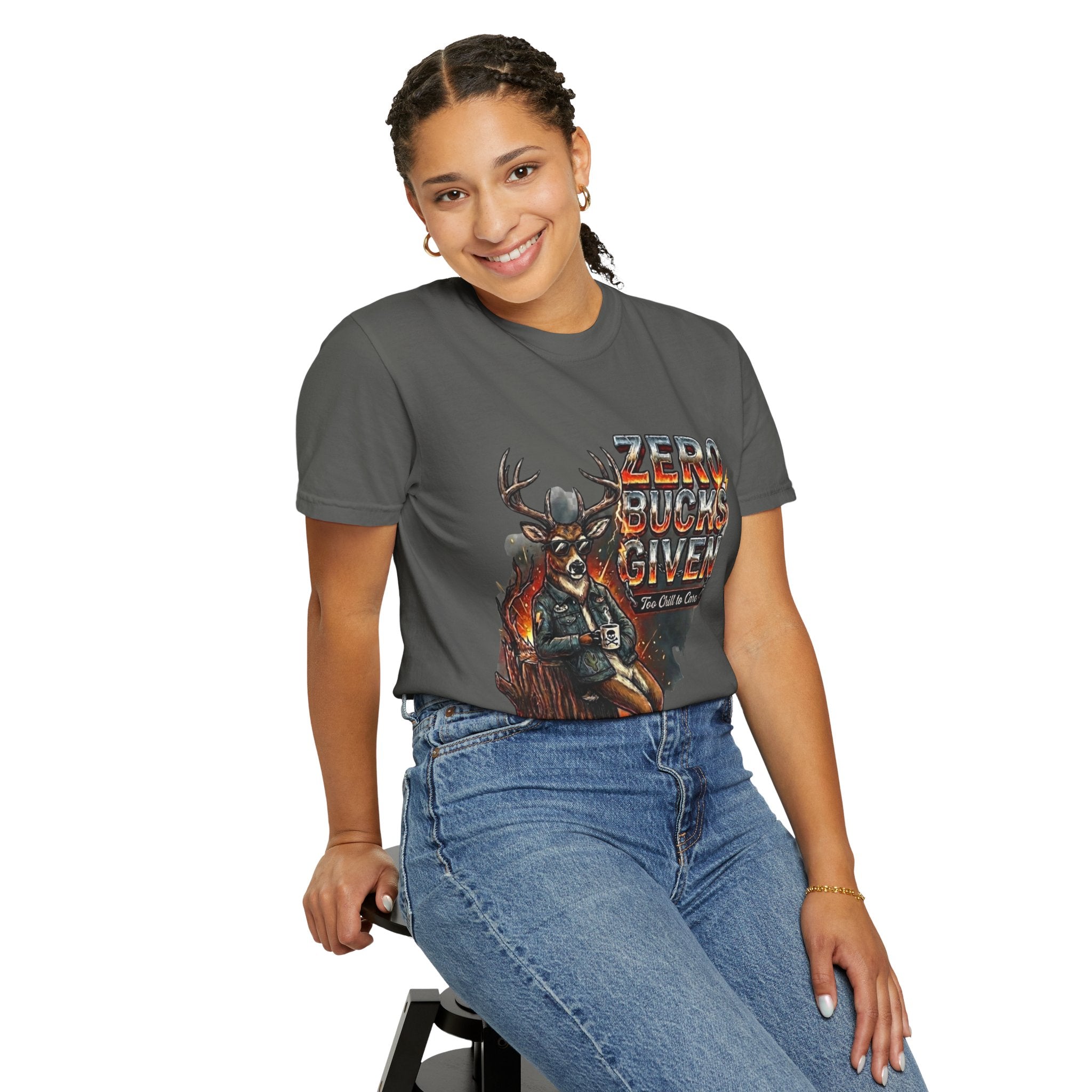 Person wearing a gray t-shirt with a graphic design and text, sitting on a stool against a white background.
