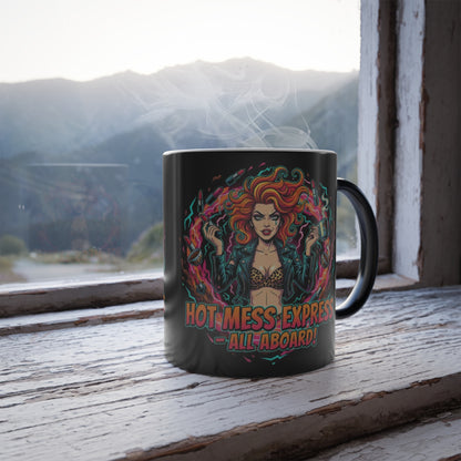 Black mug with colorful design of a woman and text 'Hot Mess Express All Aboard!' on a wooden surface with a mountain view.