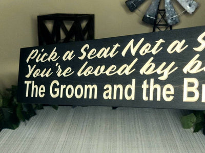 Bride and groom rustic farmhouse wedding sign displayed at the entrance.
