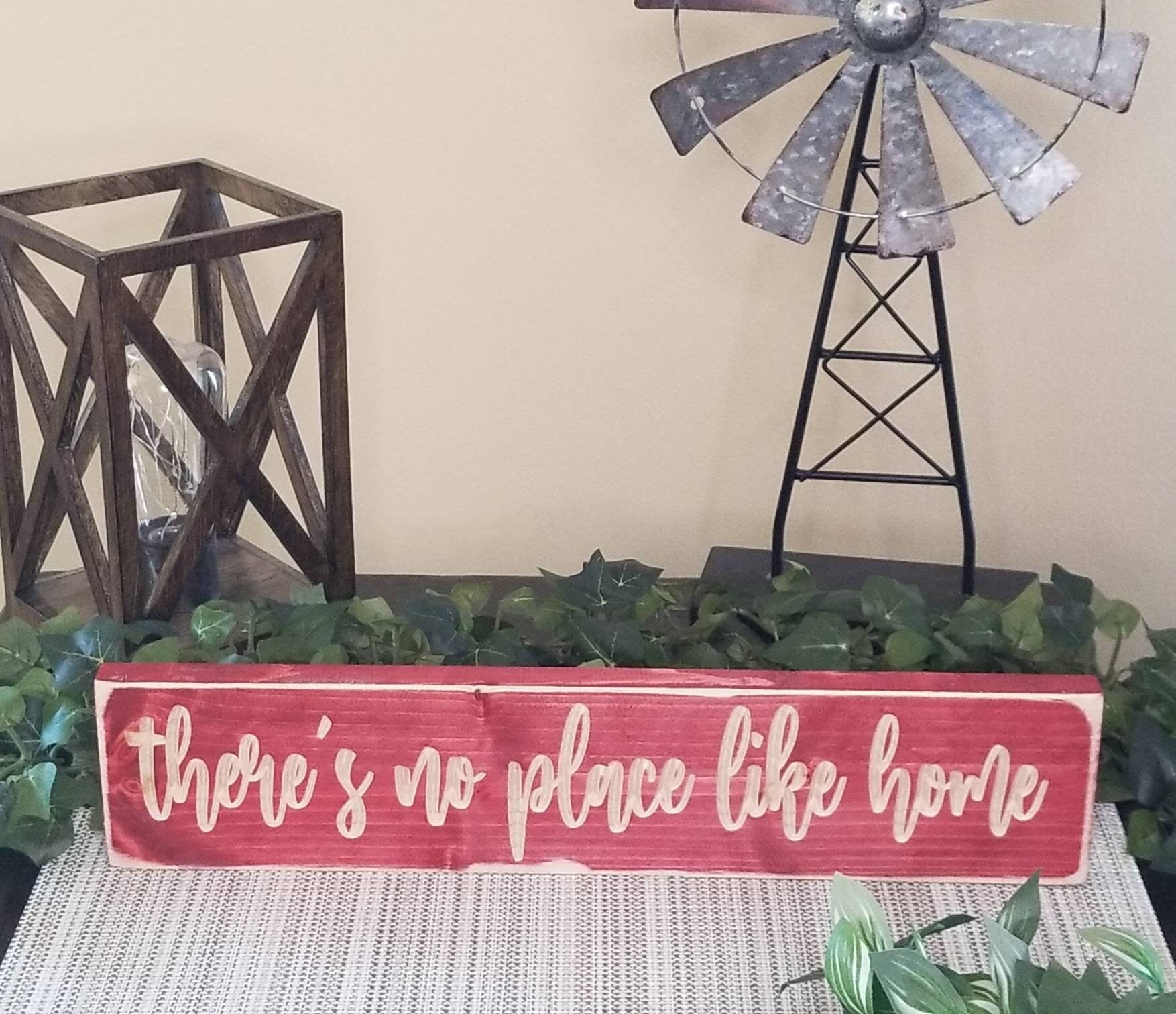 Decorative home wall art featuring a classic home sweet home quote in a family setting.
