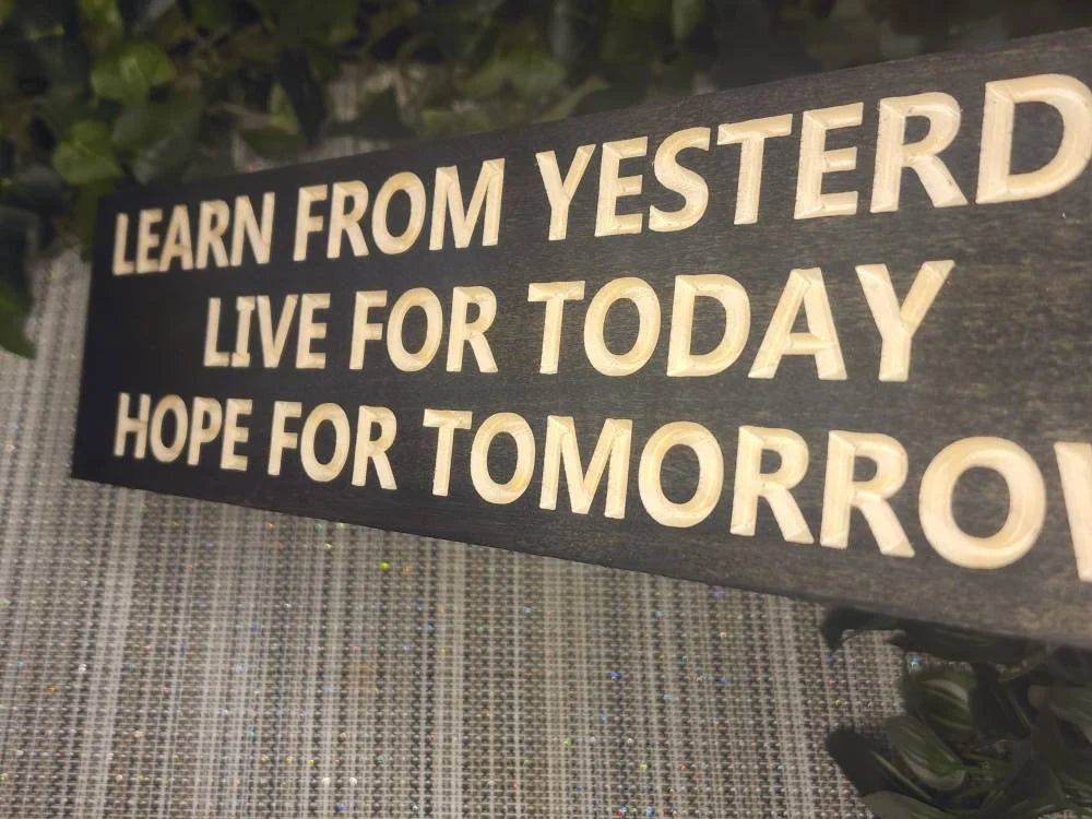 Decorative wooden sign with positive quotes styled in a peaceful living room setting.
