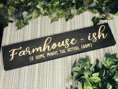 "Farmhouse-ish (A Home Minus the Actual Farm)" sign displayed as rustic farmhouse wall art in a modern home.
