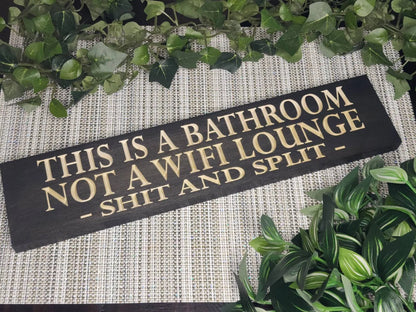 Funny bathroom wall sign that reads "This is a Bathroom, Not a WiFi Lounge – Shit and Split" in a modern guest bathroom.
