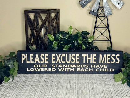Funny family wall decor sign for parents embracing the mess of parenthood.
