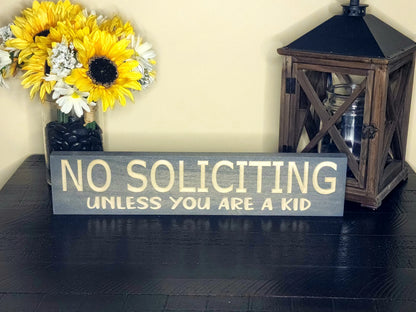 Funny no soliciting sign adding humor and charm to a cozy porch entryway.
