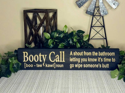 Funny parenting humor sign styled on a rustic bathroom wall for families with toddlers.
