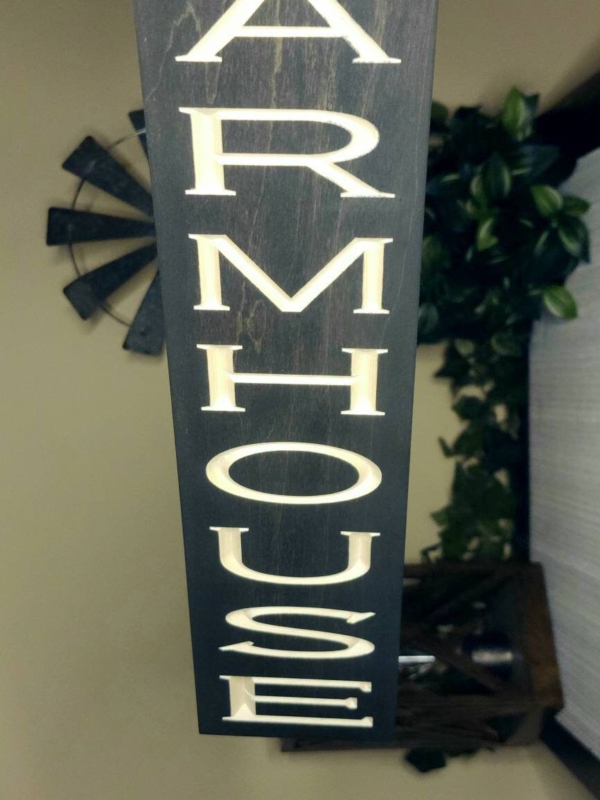 Handcrafted wooden farmhouse sign complementing rustic living room decor.
