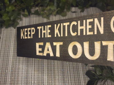 Humorous eat out wall art with quirky kitchen humor for playful home accents.
