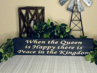 Humorous family wall art with queen-themed decor and a farmhouse style.
