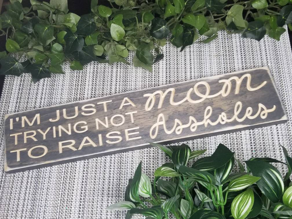 Humorous wooden mom sign for family decor and witty housewarming gifts.
