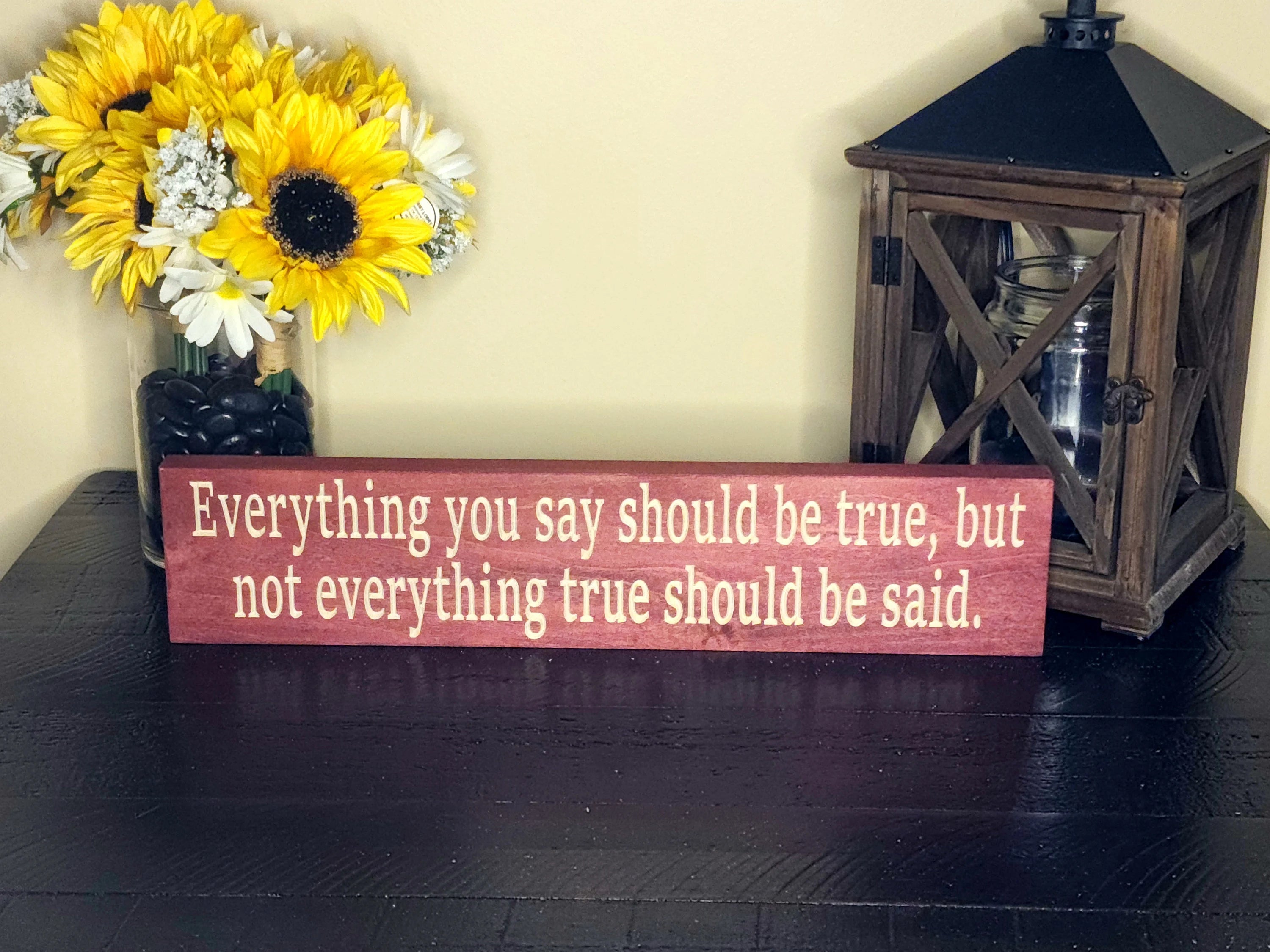 Inspirational wooden quote sign styled in a modern living room for personal growth and reflection.
