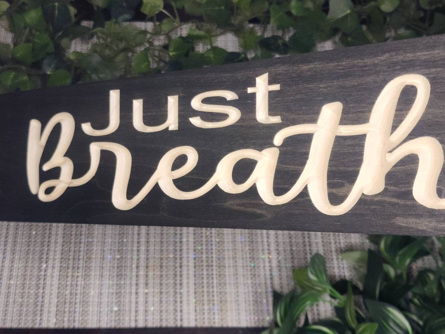 Inspirational wooden sign in a peaceful bedroom décor arrangement.

