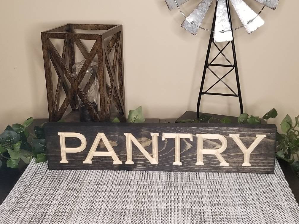 Minimalist modern pantry sign hanging in a sleek, organized kitchen.
