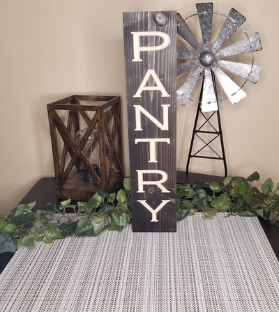 Minimalist pantry décor sign mounted on a modern kitchen wall for organization.
