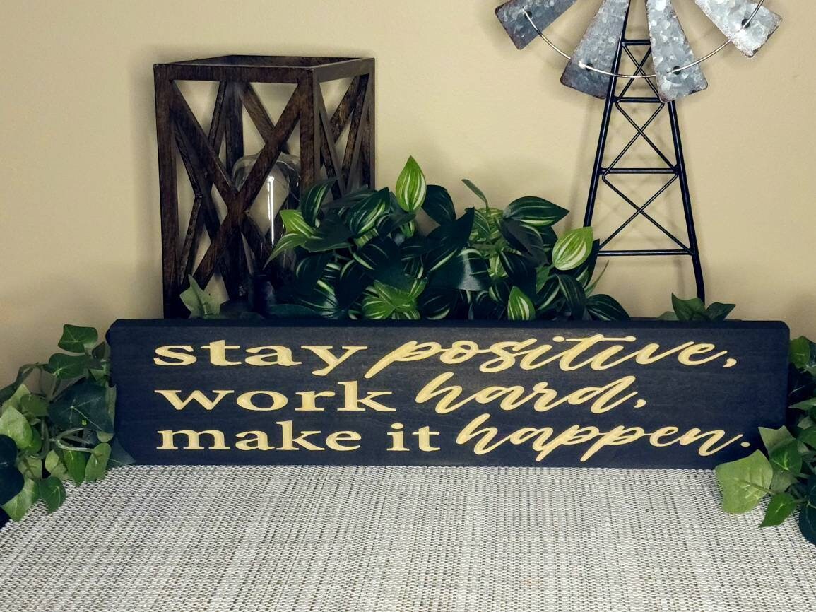 Motivational wooden wall art displayed above a student’s study desk.
