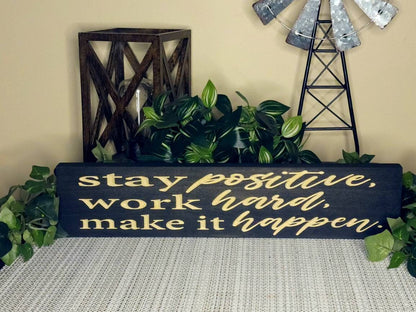Motivational wooden wall art displayed above a student’s study desk.
