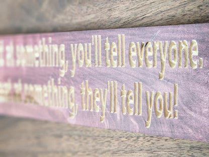 Personalized motivational wooden sign displayed in a workspace.
