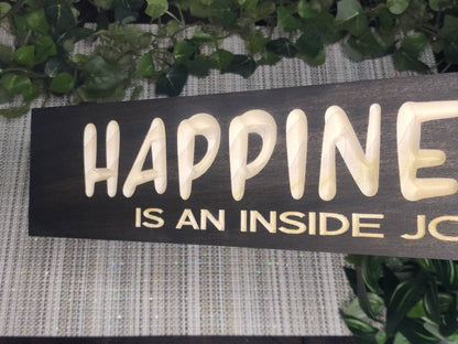 Positive affirmation wall art featuring a wooden happiness quote sign.
