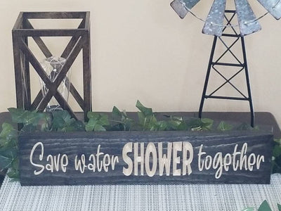 Romantic wooden wall art for couples, featuring playful bathroom humor.
