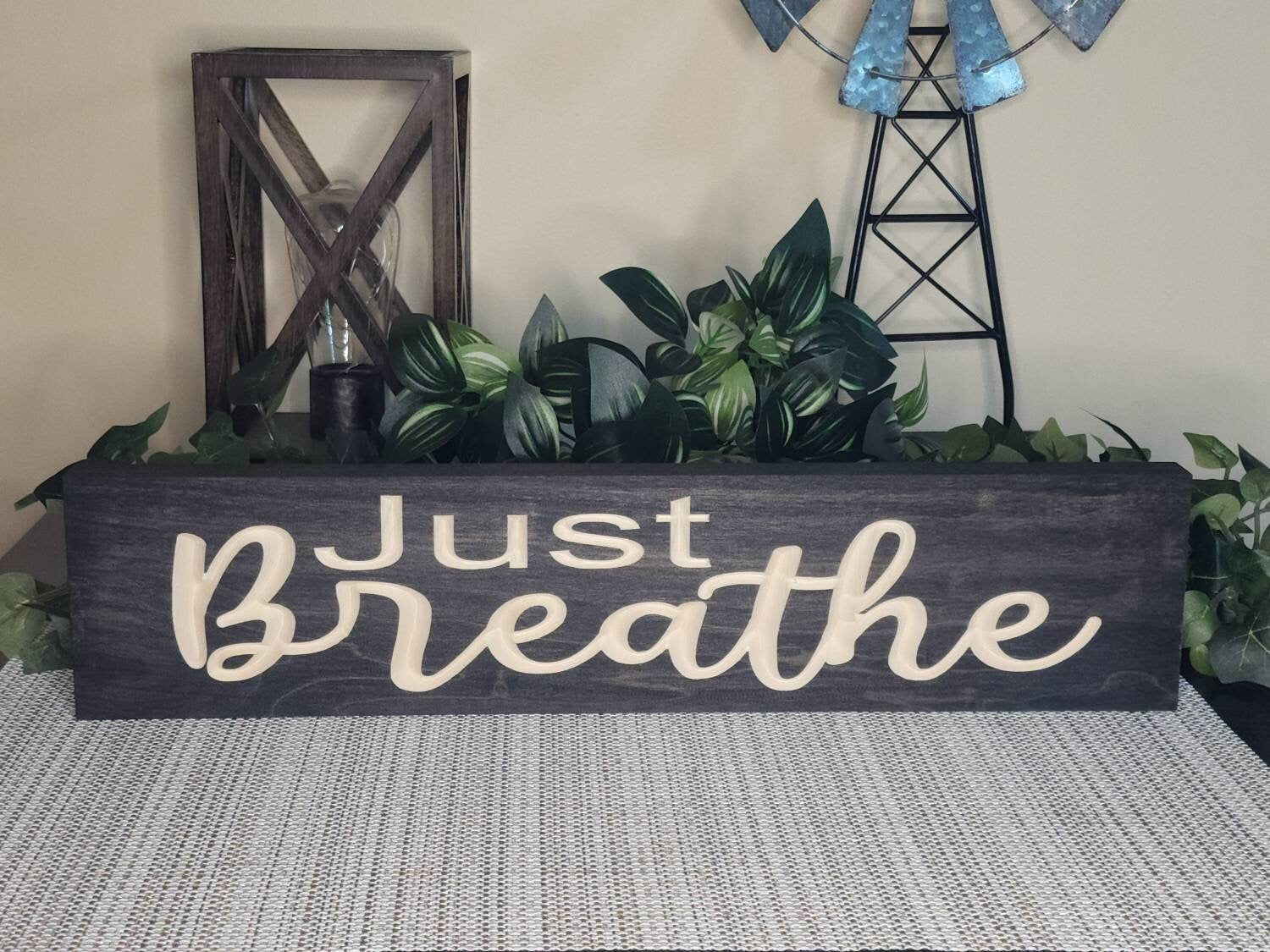 Rustic wall art with a calming message for mindfulness spaces.
