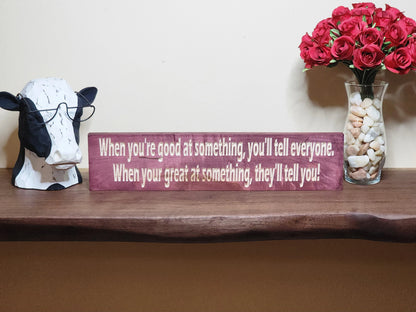 Rustic wooden motivational sign styled on a study room wall for daily inspiration.
