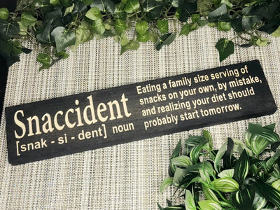 Snaccident wood sign for funny kitchen decor and snack-themed wall art.