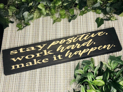 Stay Positive, Work Hard, Make It Happen wooden sign styled in a modern home office.
