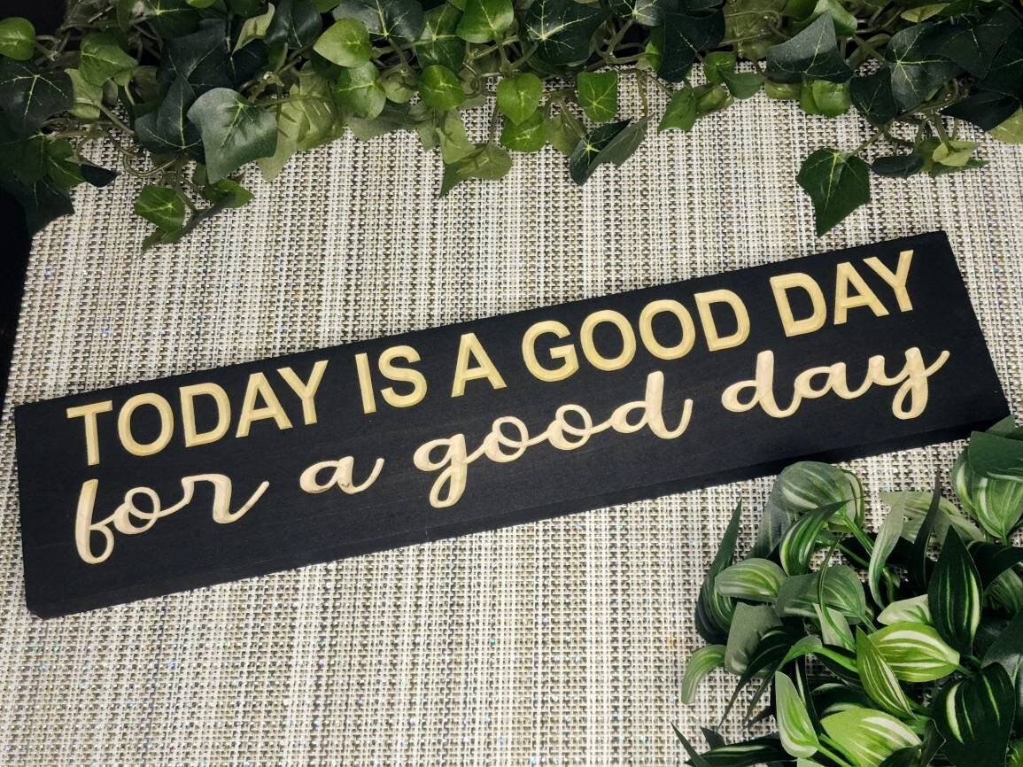 "Today is a Good Day for a Good Day" wooden sign displayed in a bright and cozy entryway.
