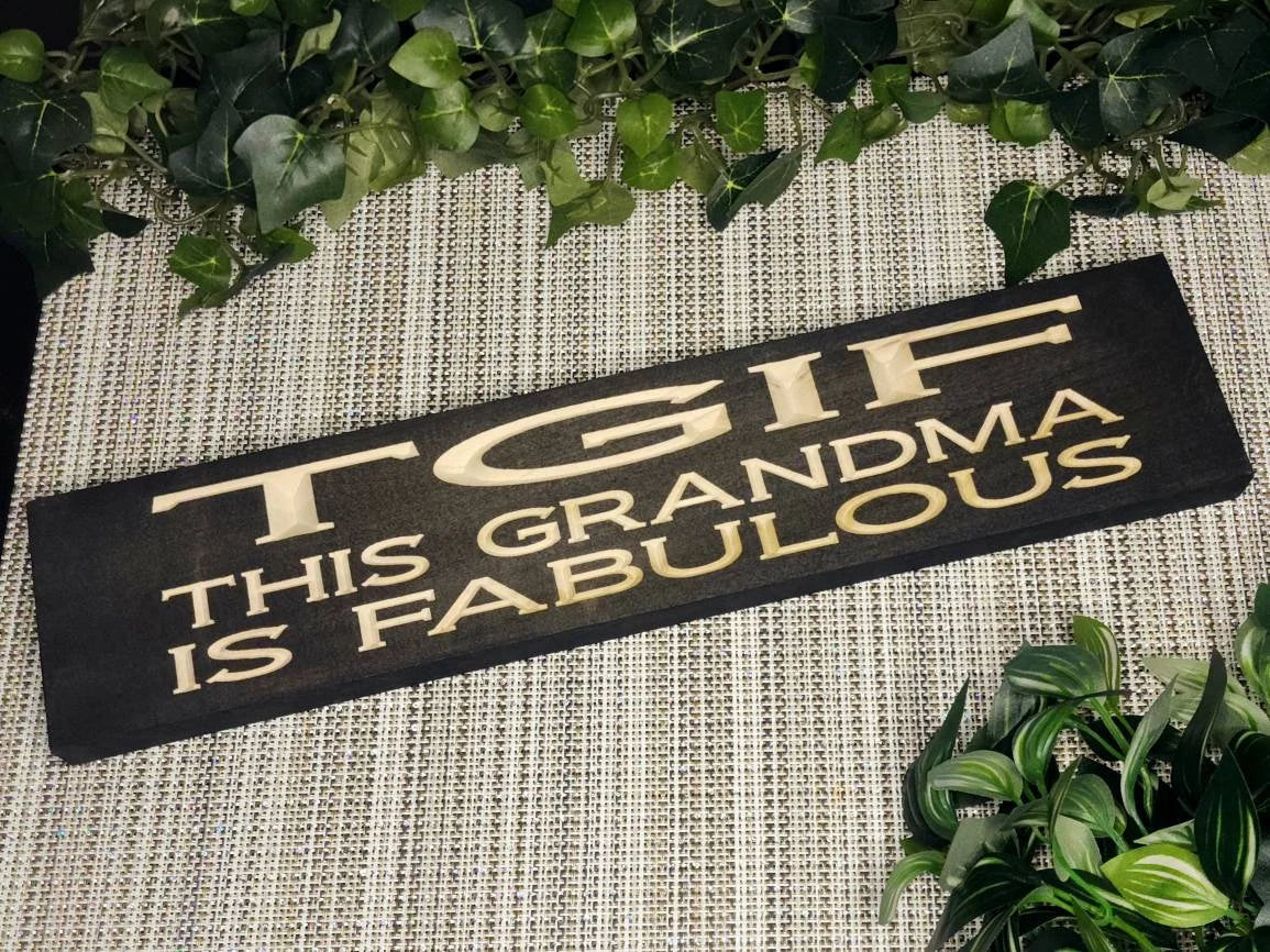 Wooden TGIF - This Grandma is Fabulous sign displayed in a cozy farmhouse-style living room.
