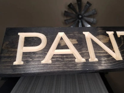 Wooden pantry door sign with rustic charm and farmhouse appeal.
