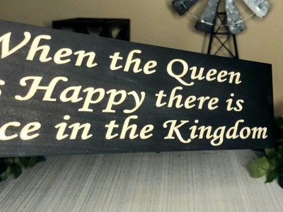 Wooden quote sign with playful text for family harmony and rustic charm.
